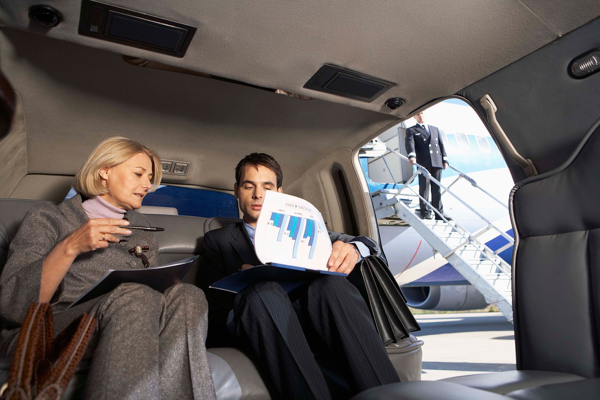 business persons discussing in a limousine