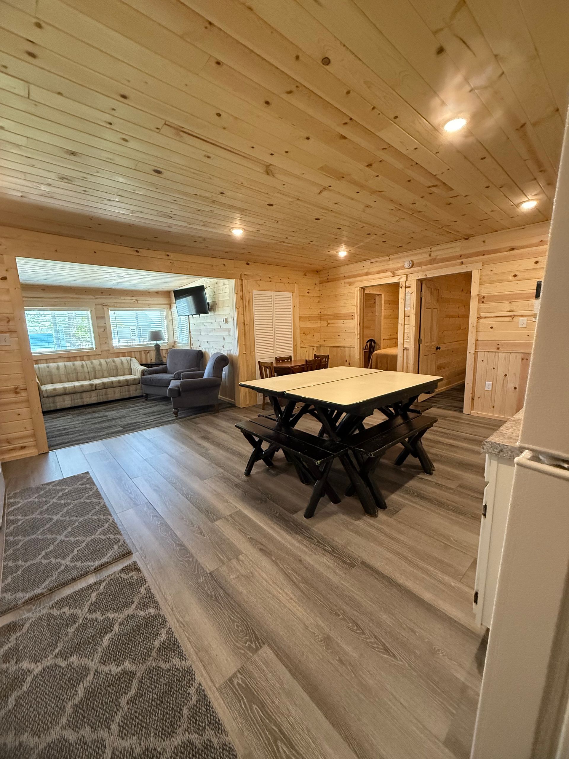 A living room with a table and chairs in it.