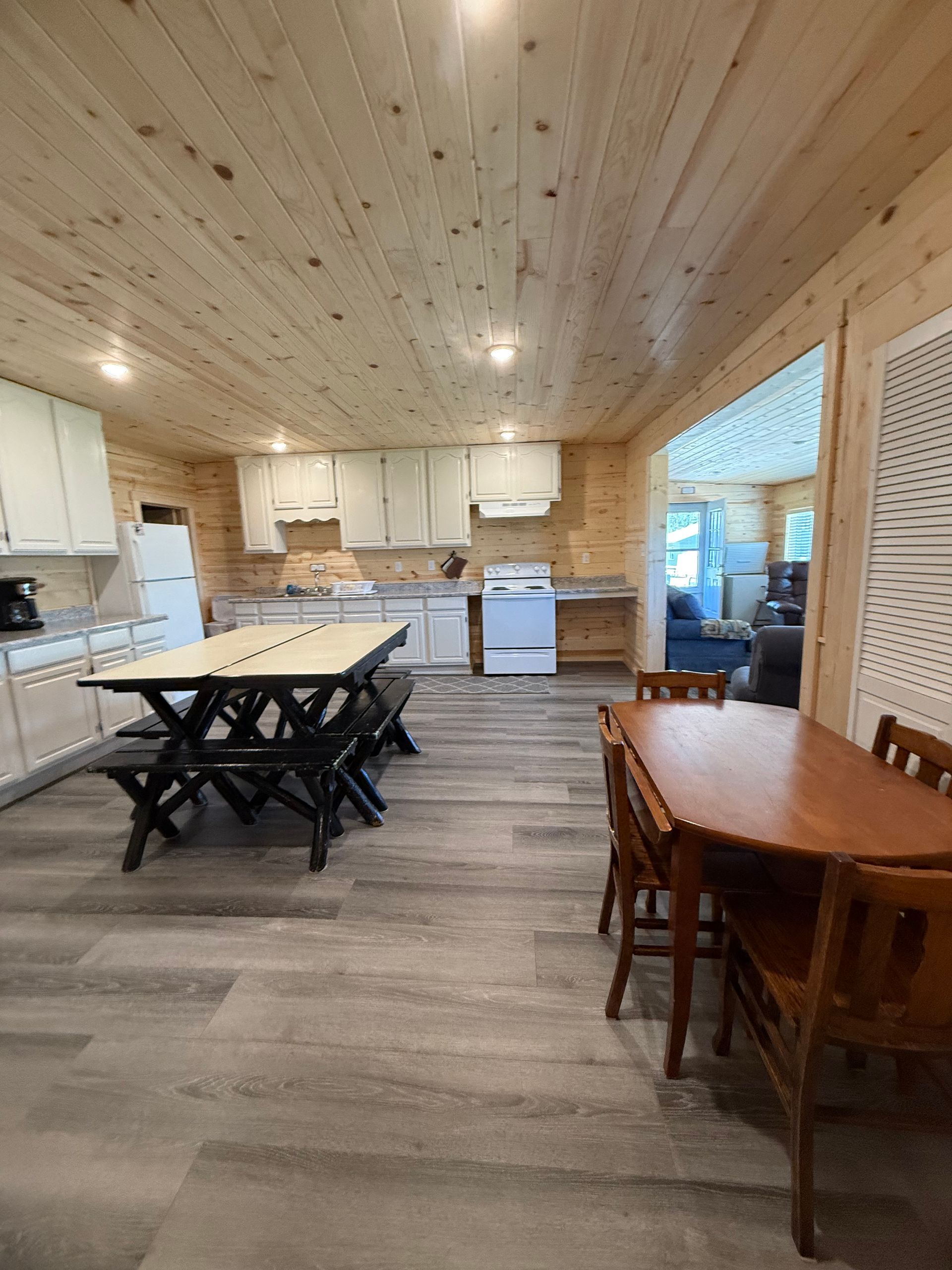 There is a table and chairs in the middle of the room.