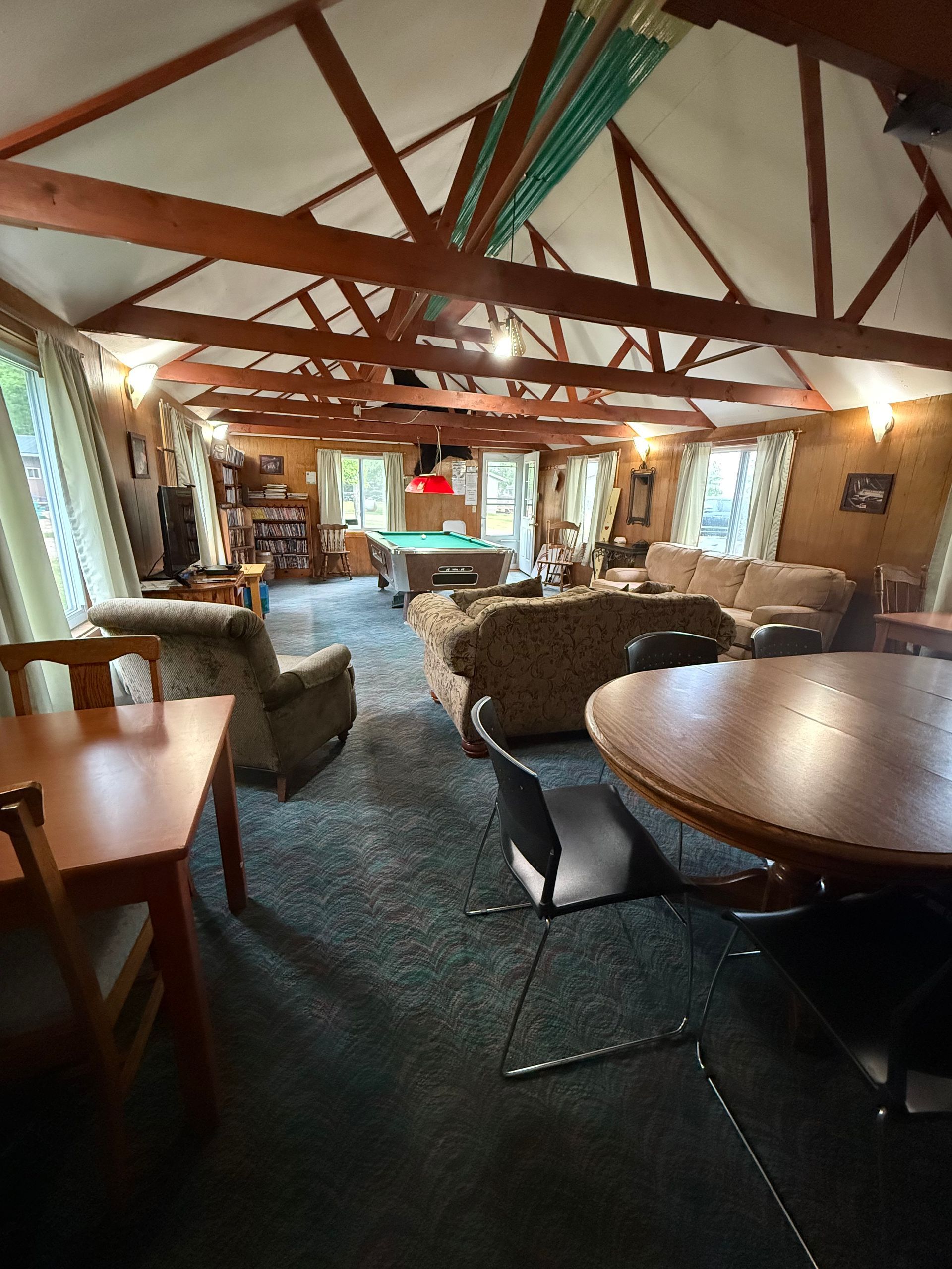 A living room filled with furniture and a pool table