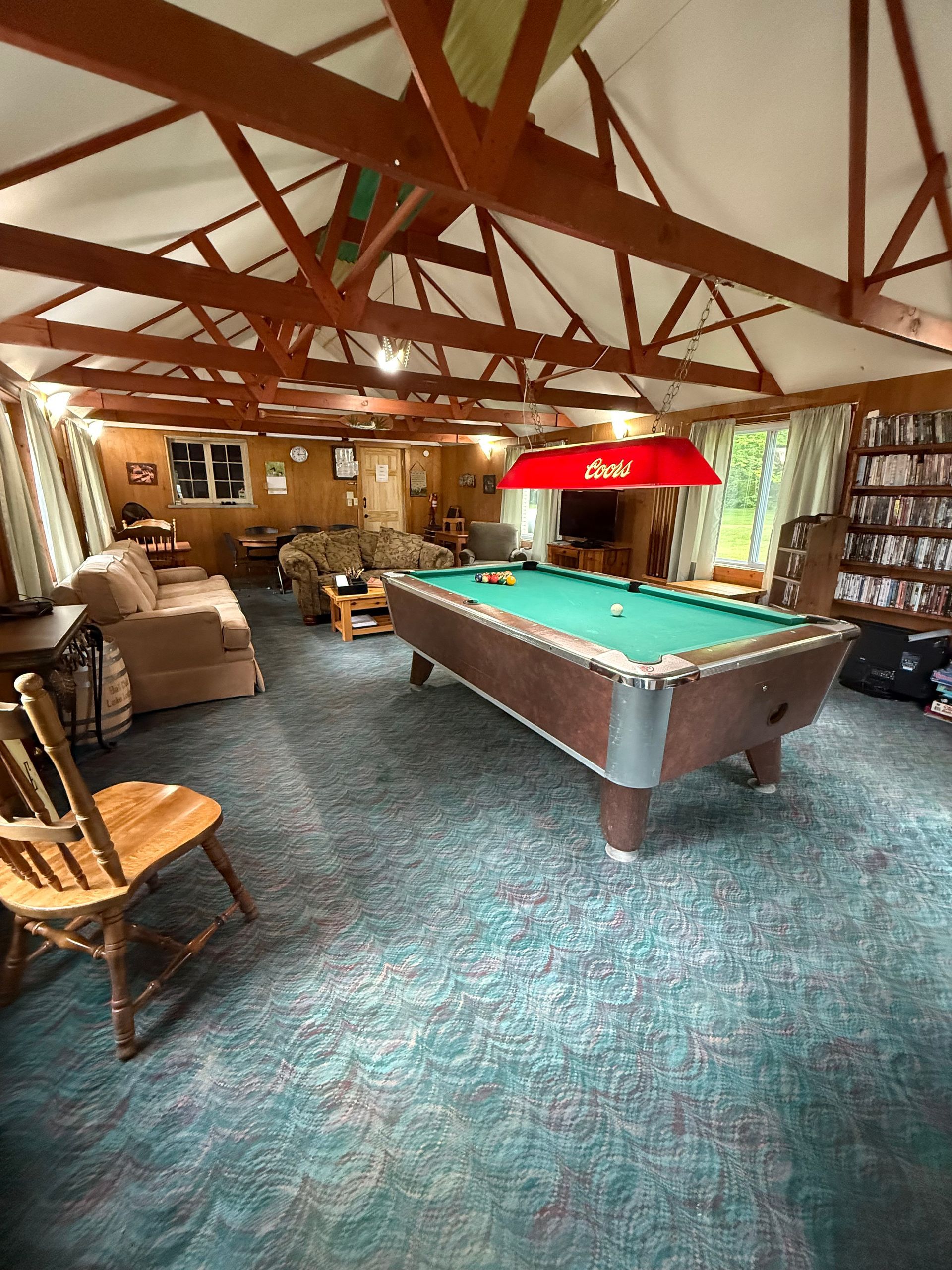 There is a pool table in the middle of the room.