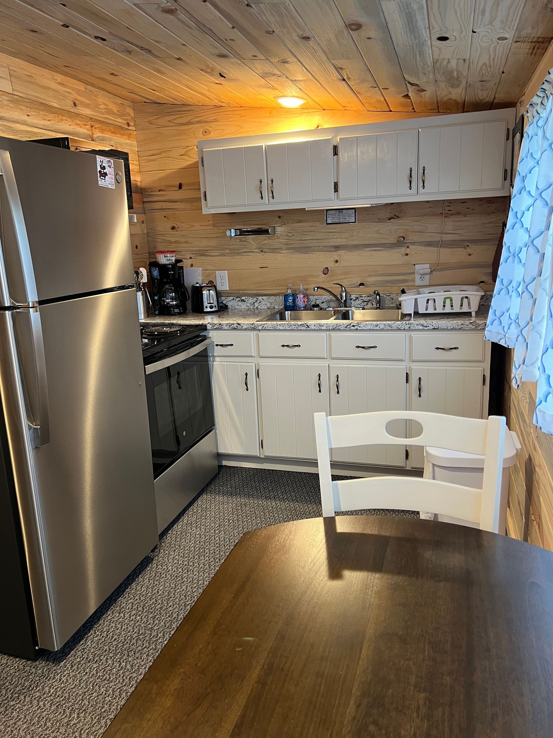 A kitchen with stainless steel appliances and white cabinets