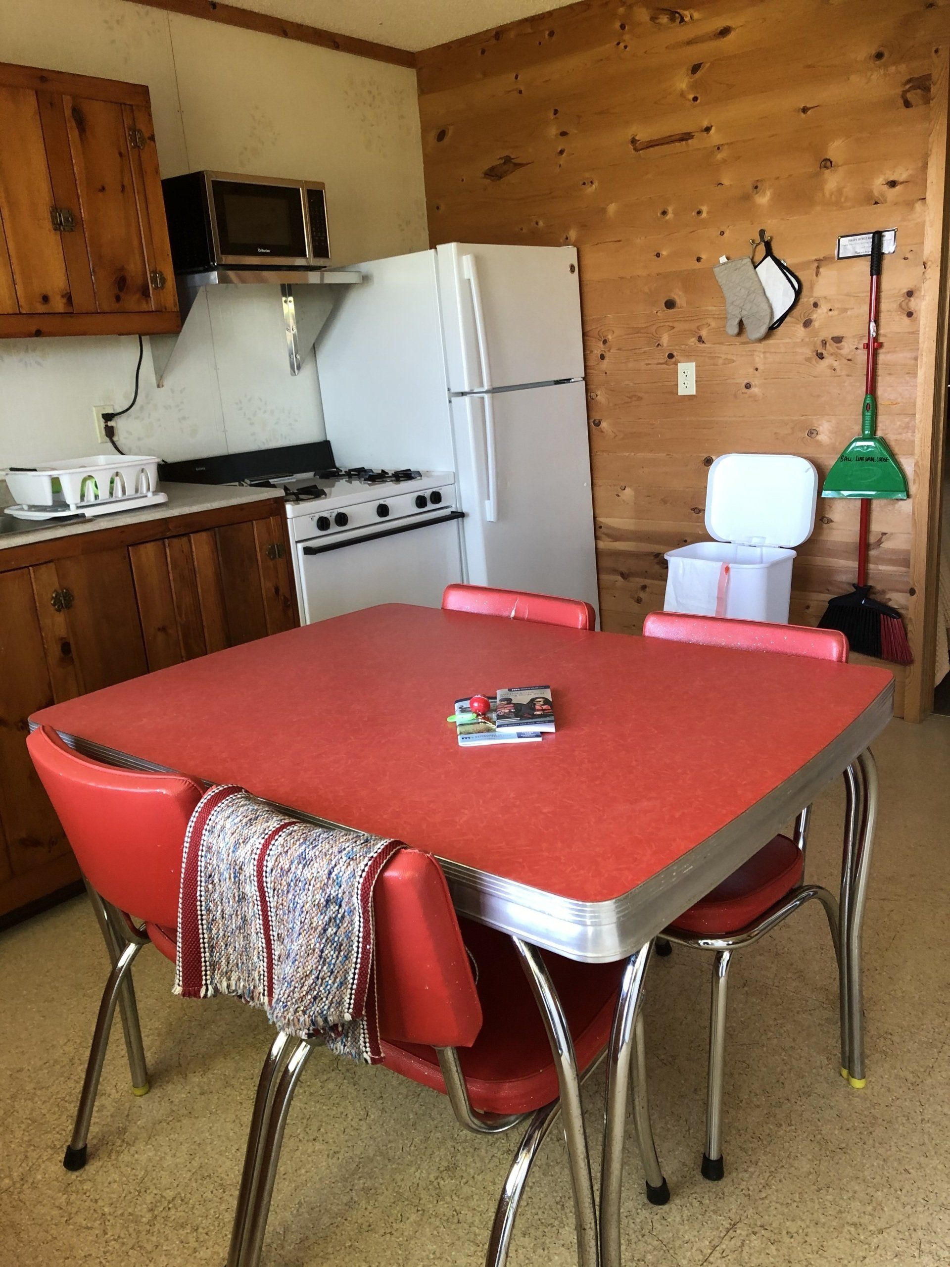 Red table and chairs with ref in the kitchen