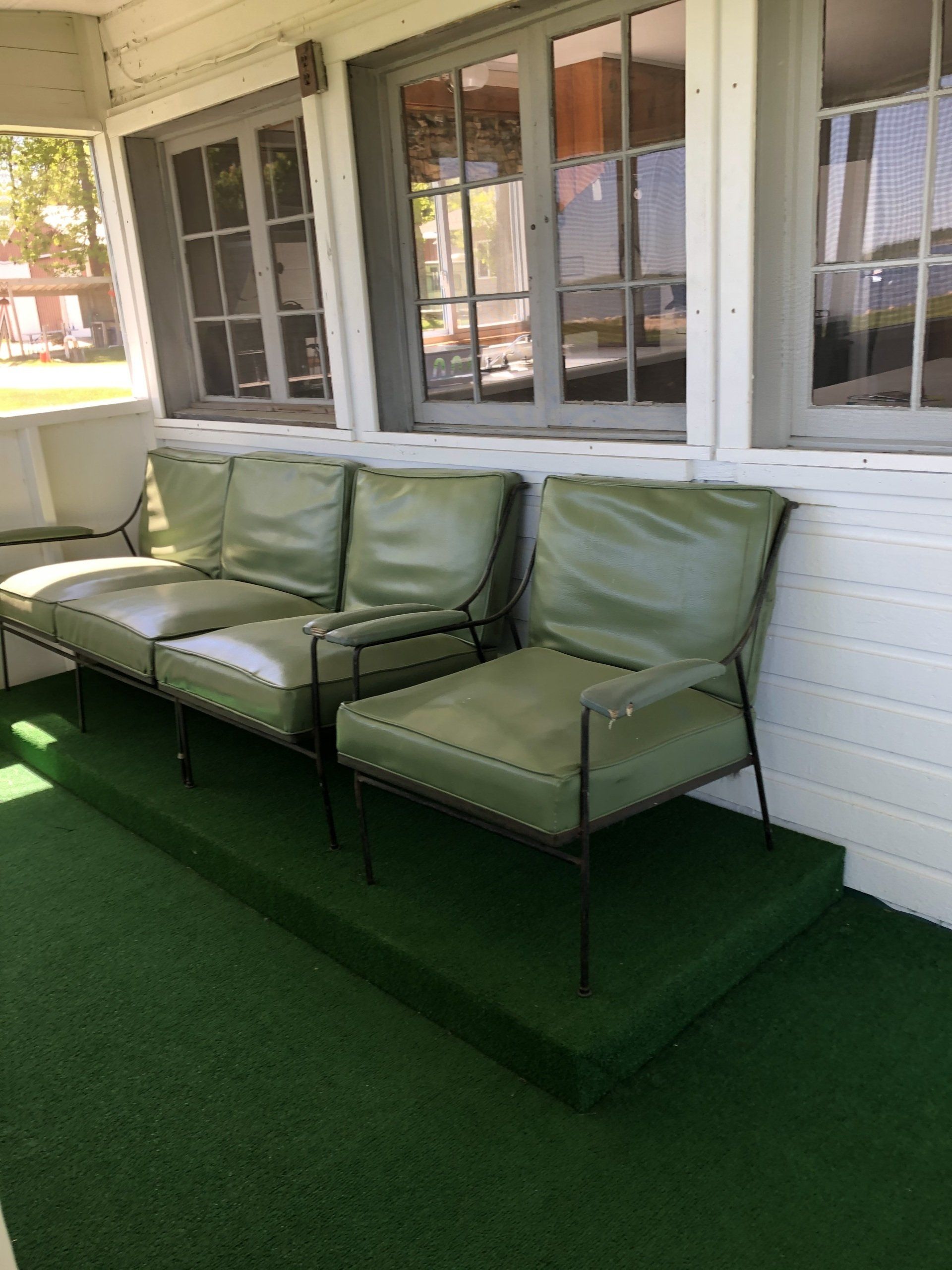 Green chairs outside the cabin