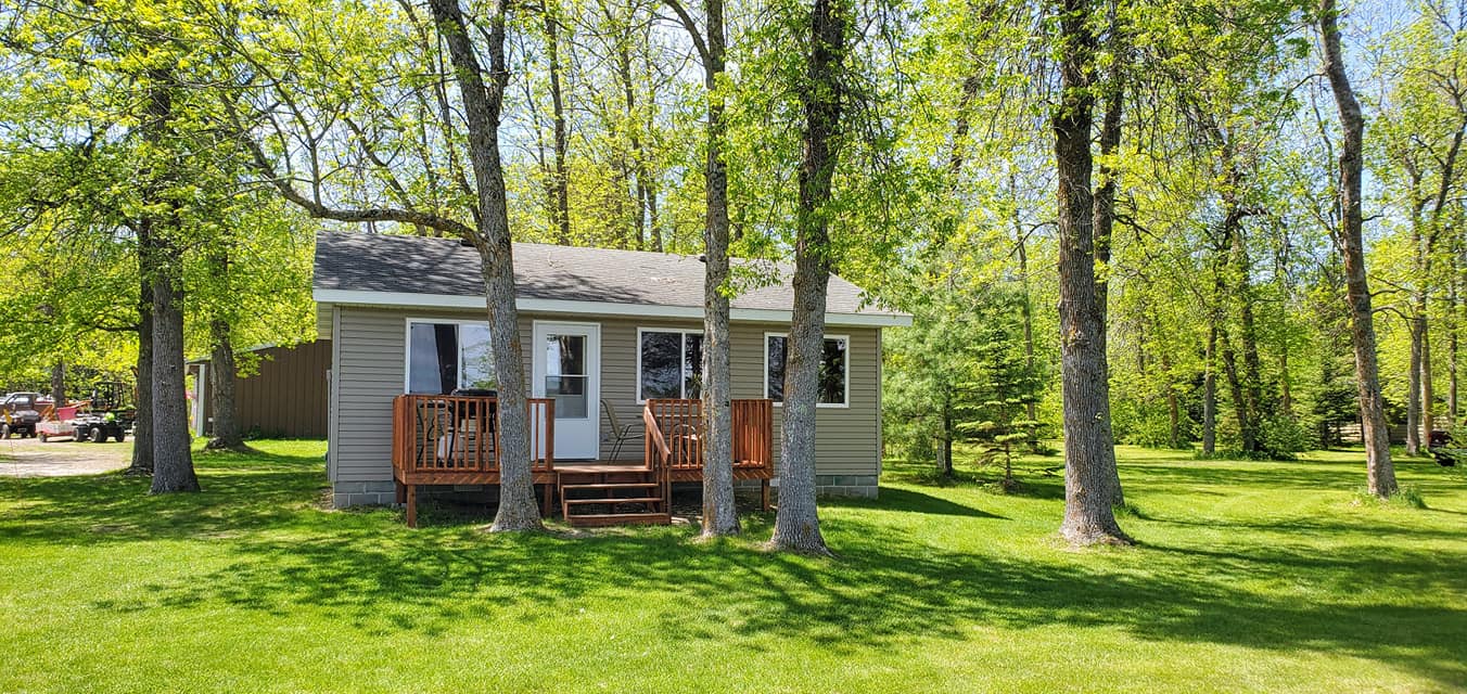 A wooden cabin with trees