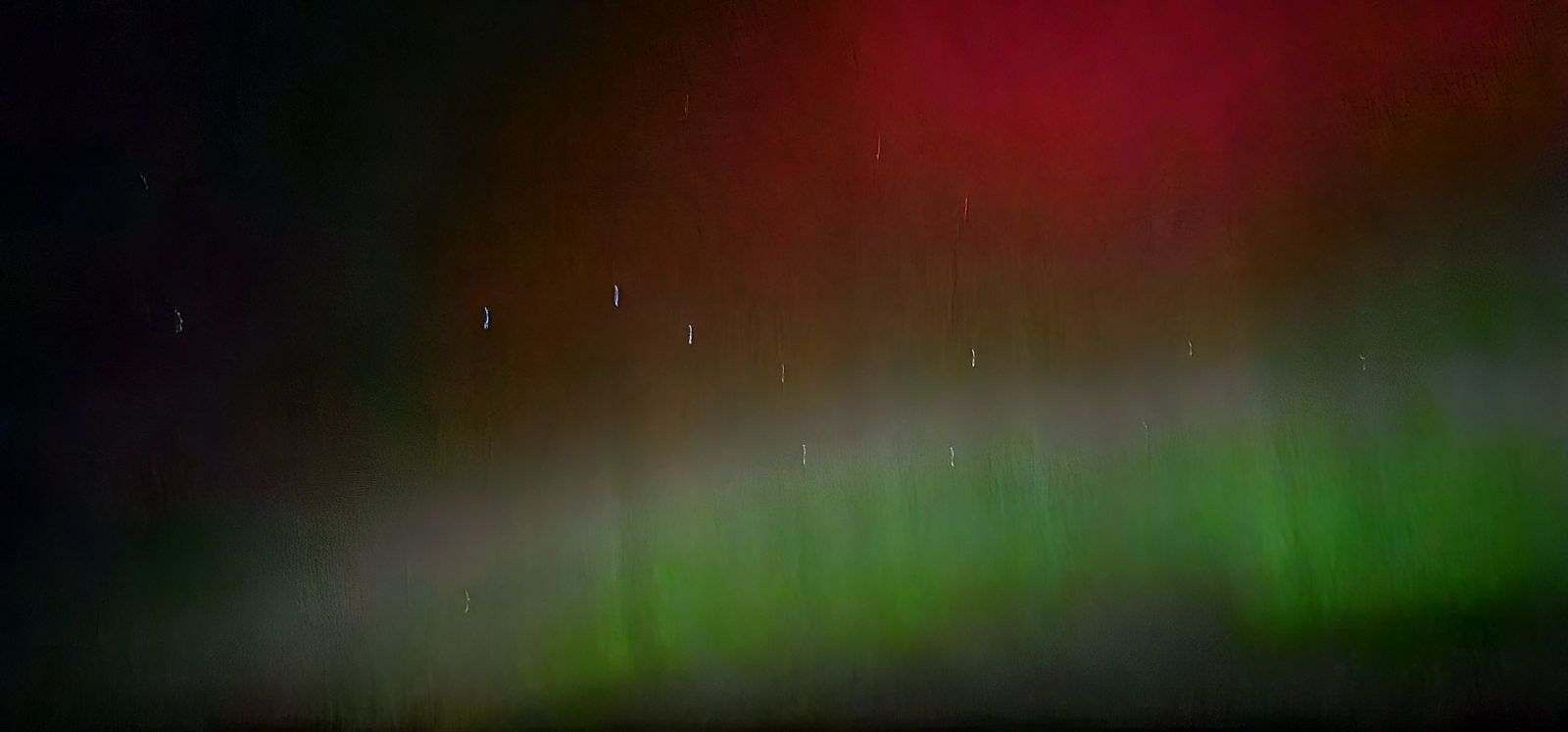 A blurry picture of the aurora borealis in the night sky.