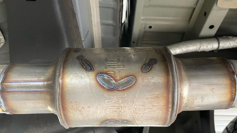 A close up of a catalytic converter on a car.
