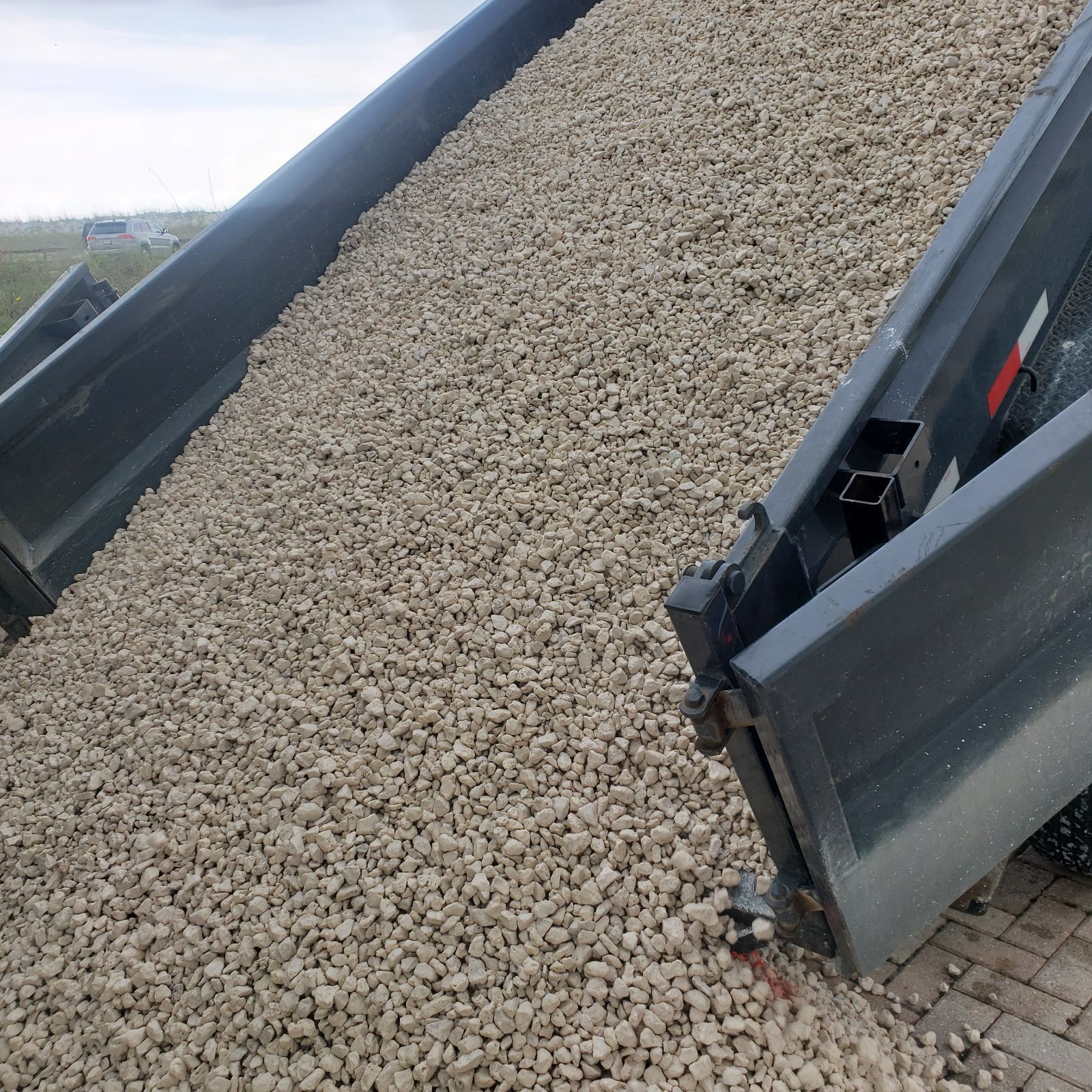 Dump truck dumping gravel.