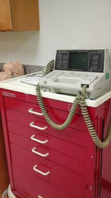 A red cabinet with a telephone on top of it.