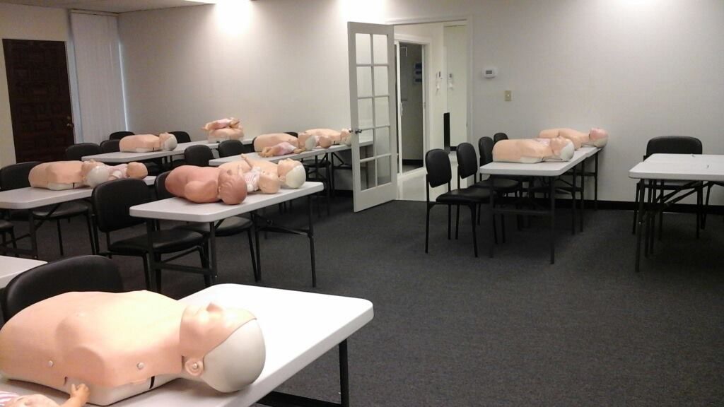 A room with tables and chairs and mannequins on them