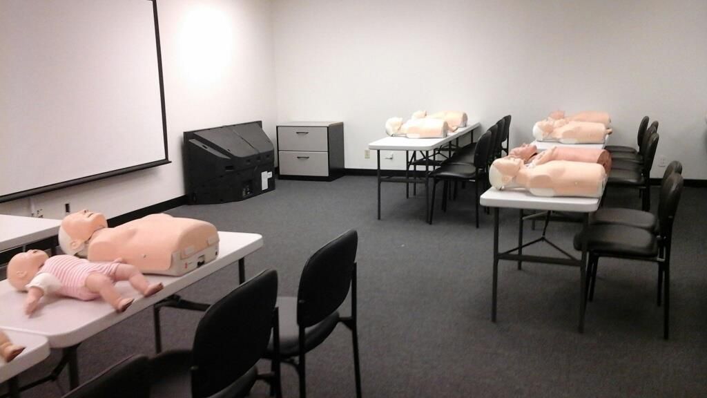 A room with tables and chairs and mannequins on them