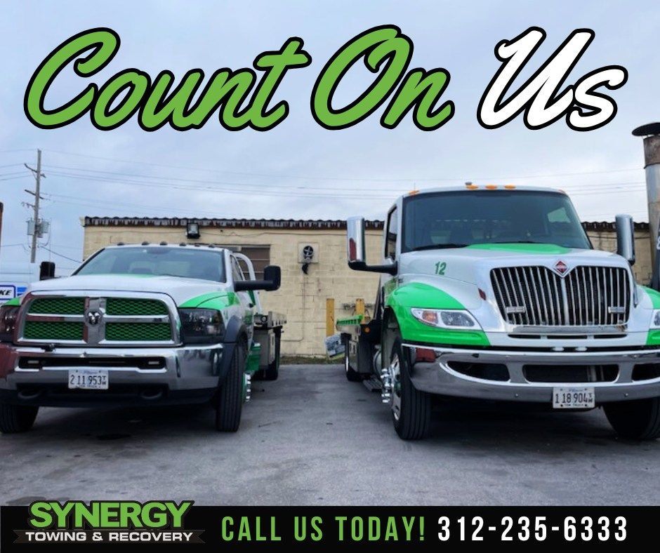 Two tow trucks with green accents. Text: 