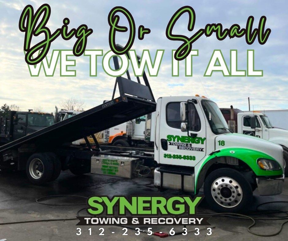 A tow truck with green accents. Text: 