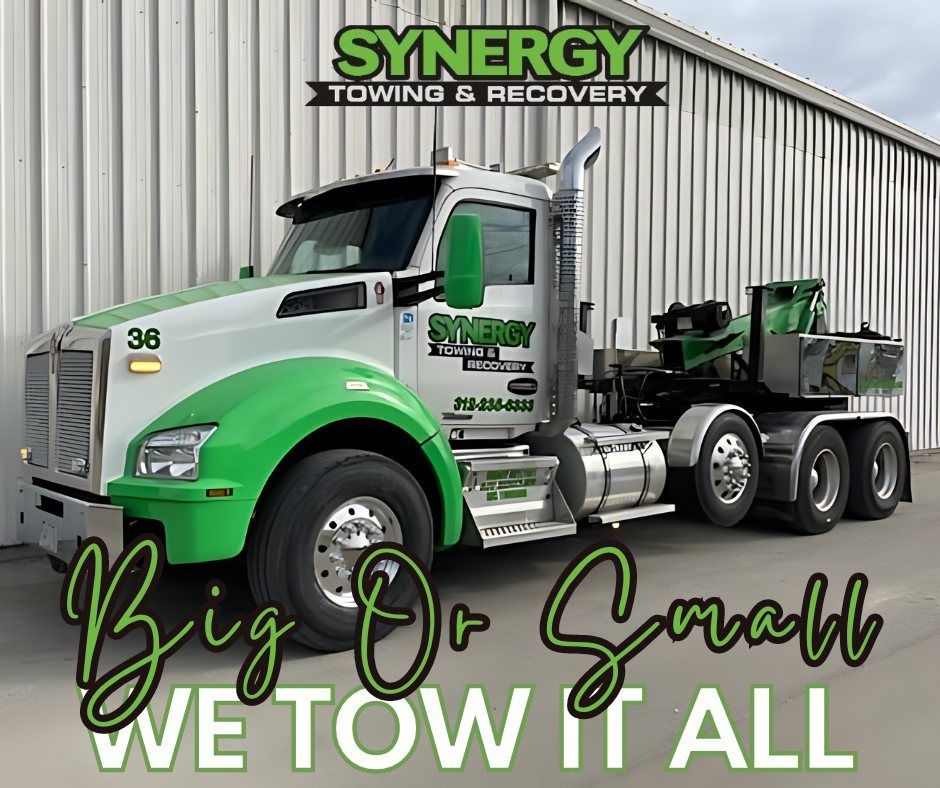 Green and white tow truck with 