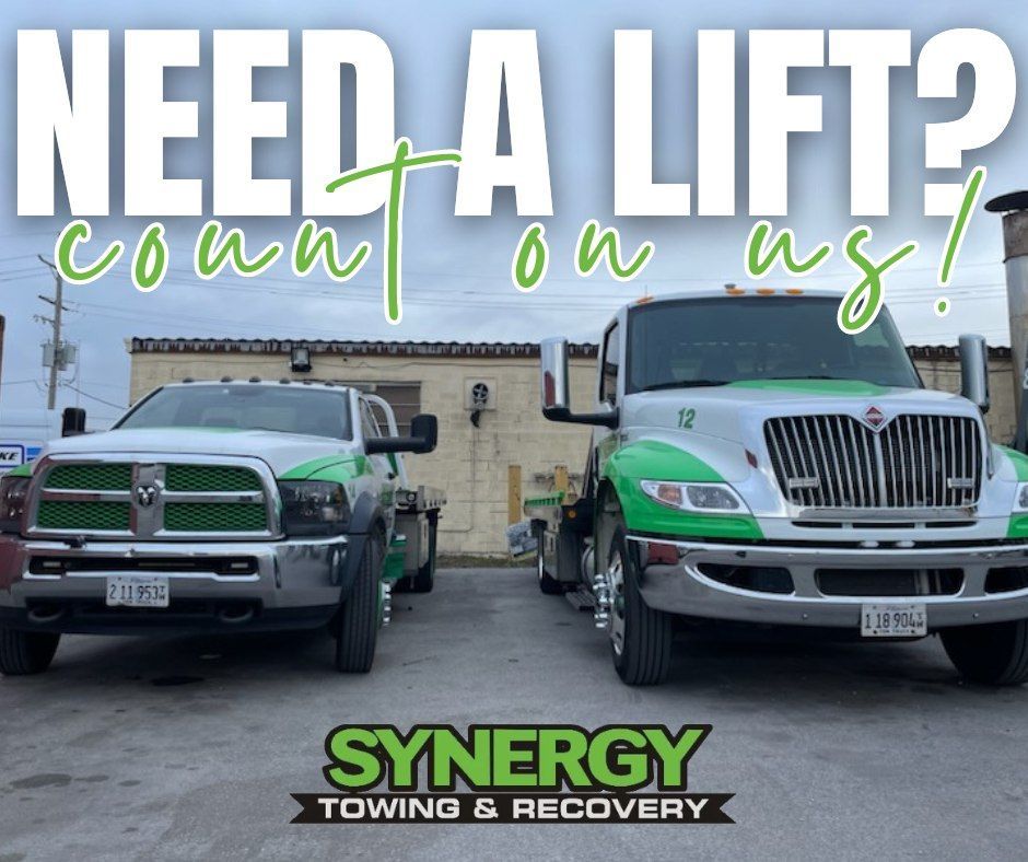 Two tow trucks with green accents. Text: 