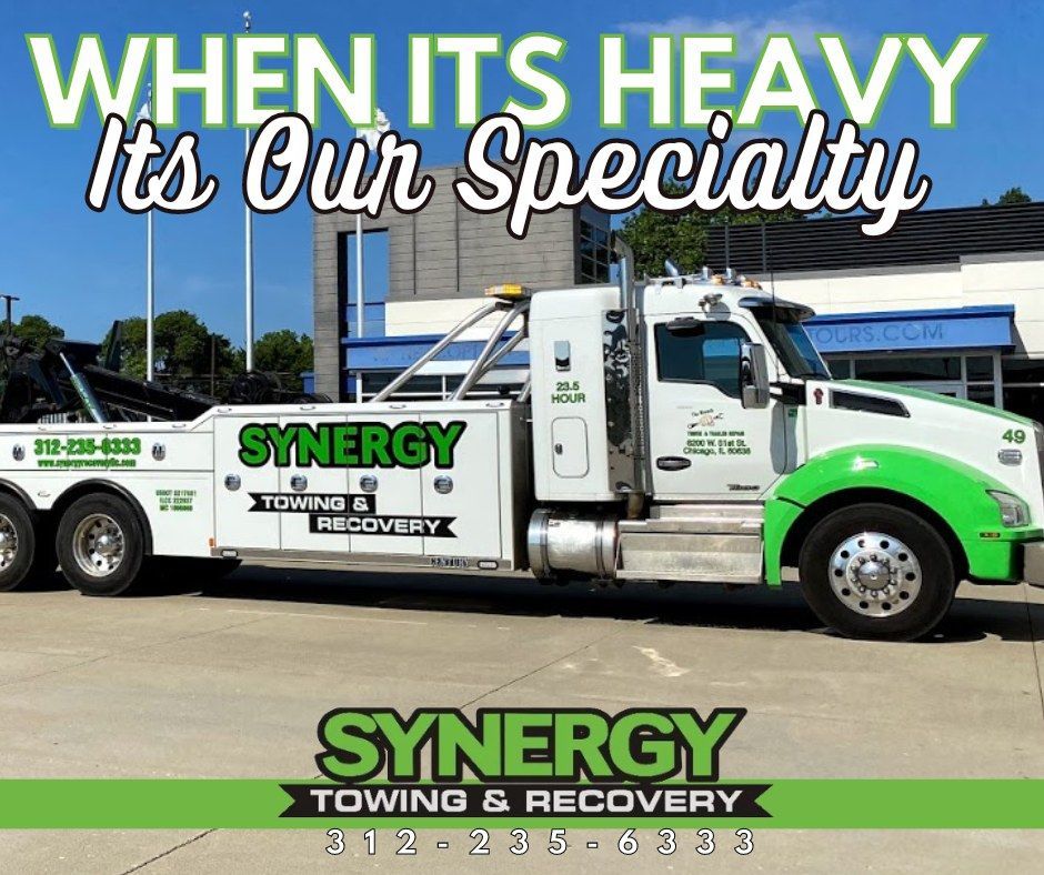 A white and green Synergy Towing & Recovery tow truck; 