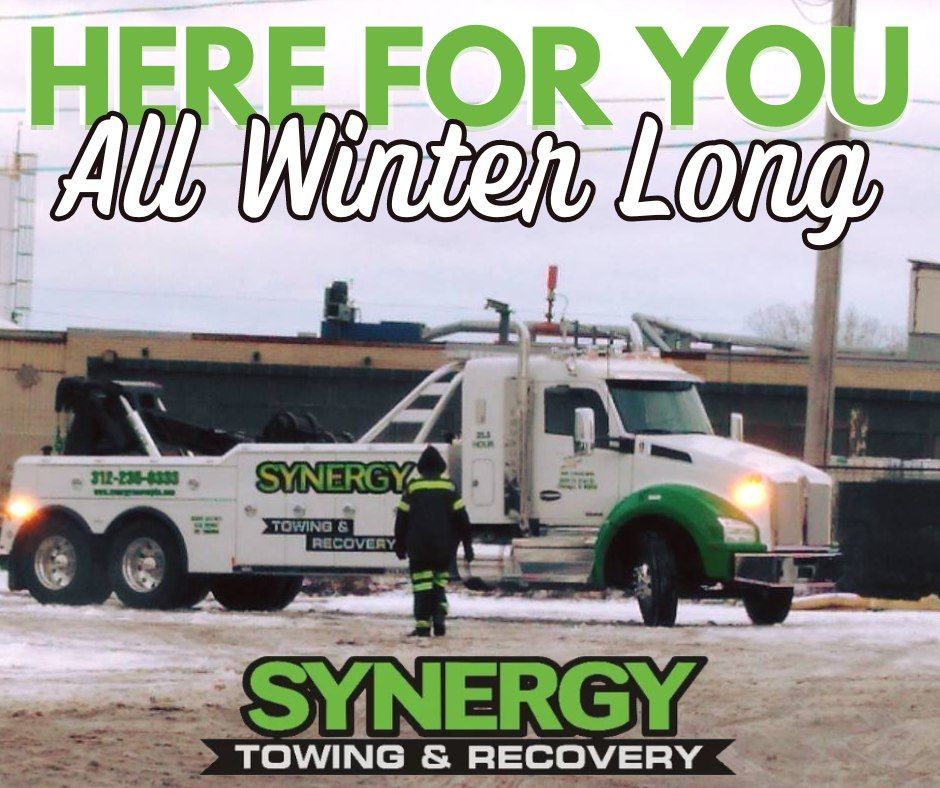 Tow truck with a person standing nearby in a winter setting; text: 