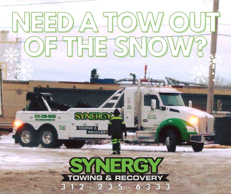 Tow truck in snow with ad text: 