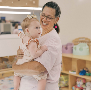 Woman holding a baby.