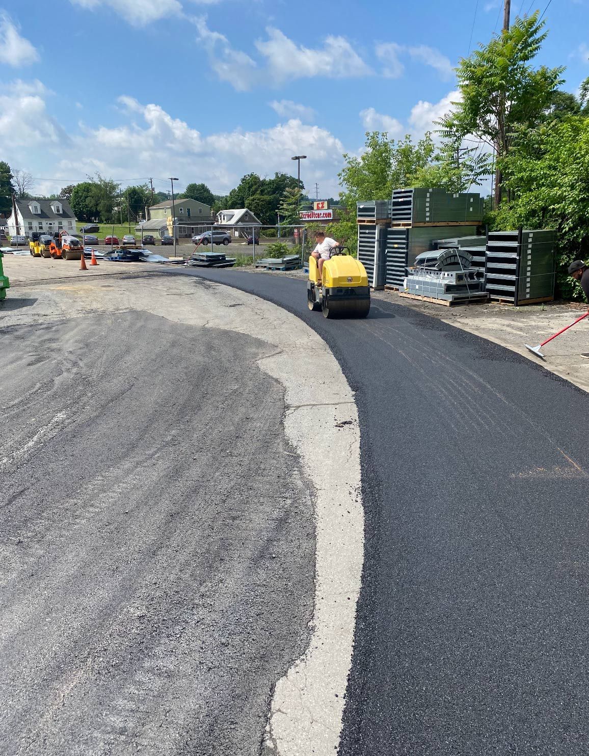 A man is riding a yellow roller on a road.