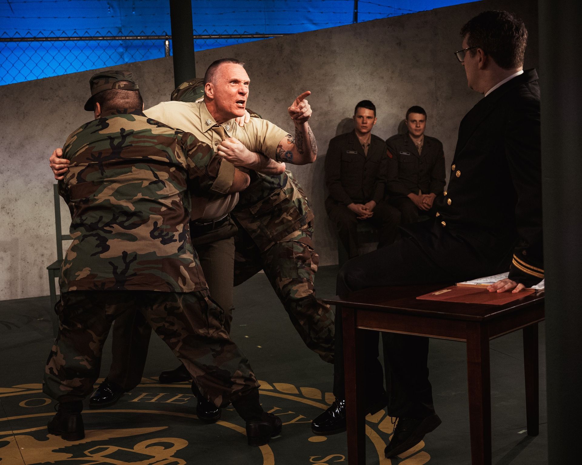 A group of men in military uniforms are standing around a table