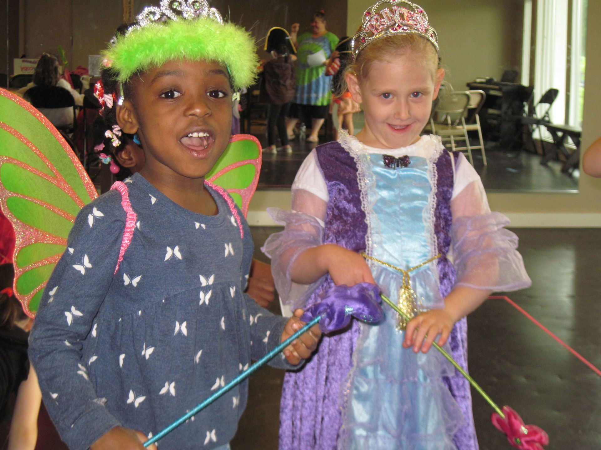 Two little girls dressed up as fairy and princess