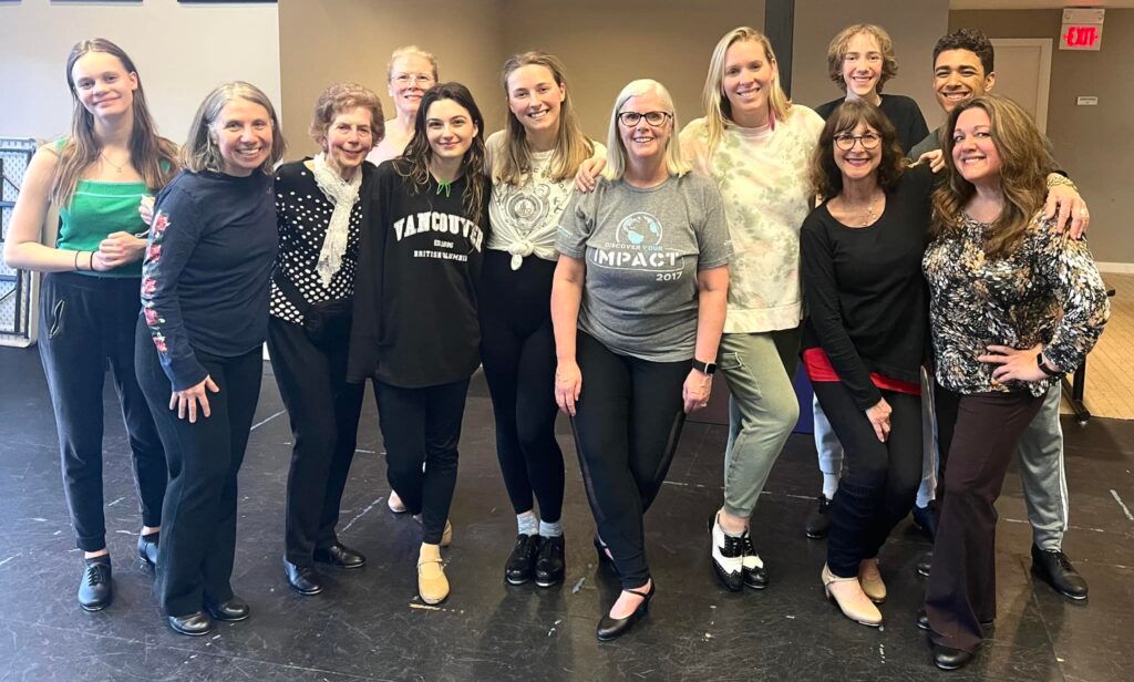 A group of women are posing for a picture in a room.