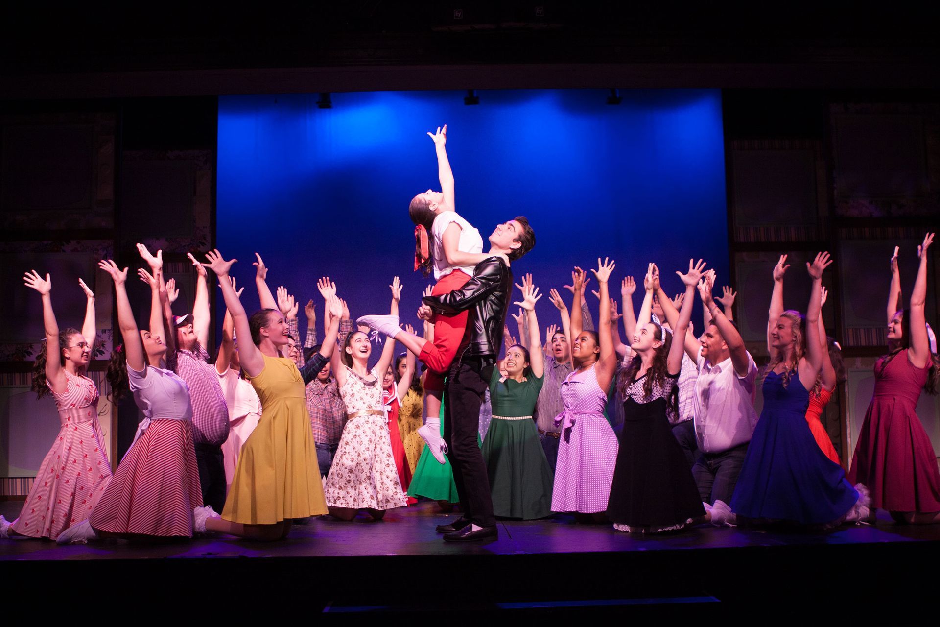 A group of people are dancing on a stage.