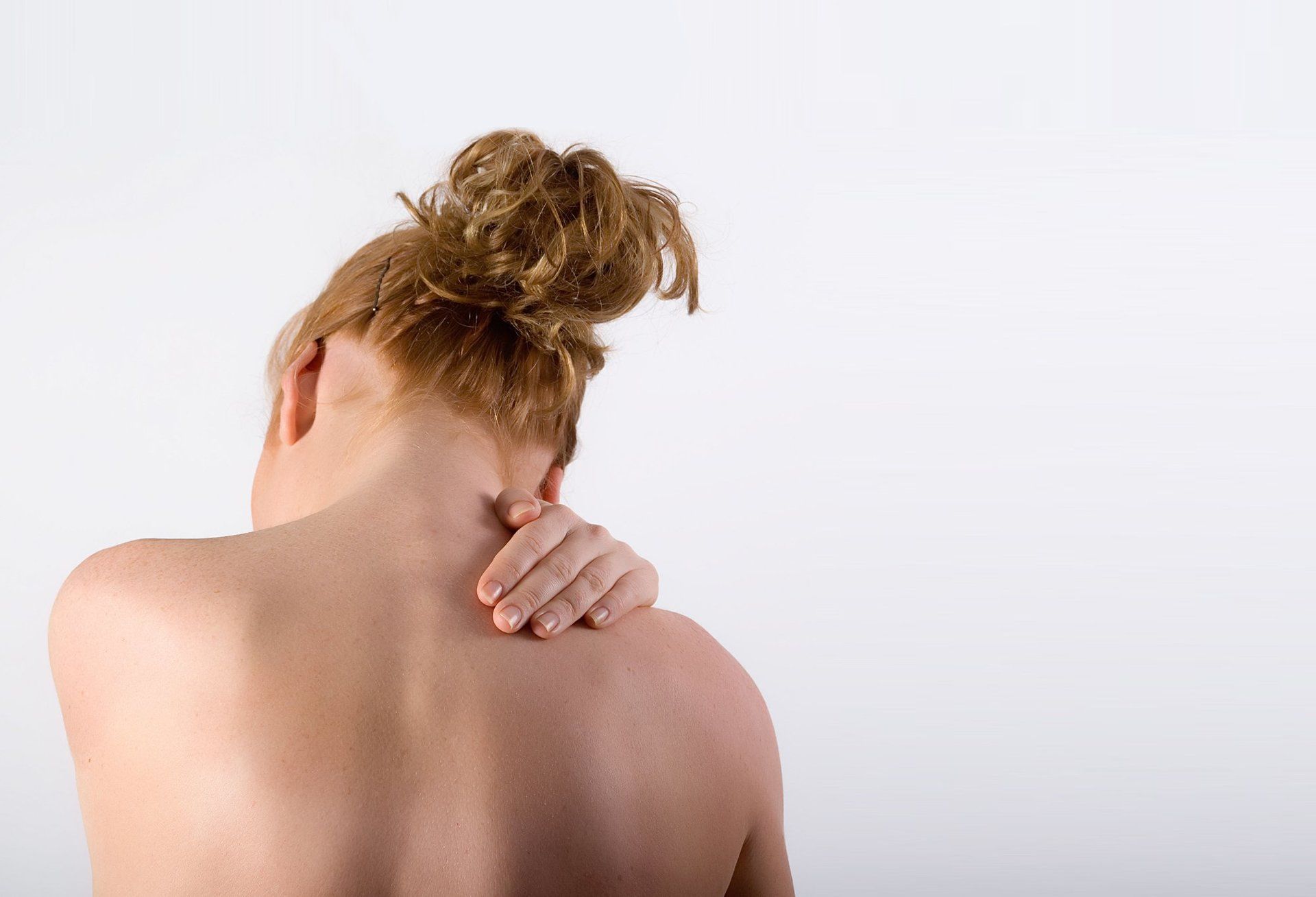 Woman holding shoulder in pain