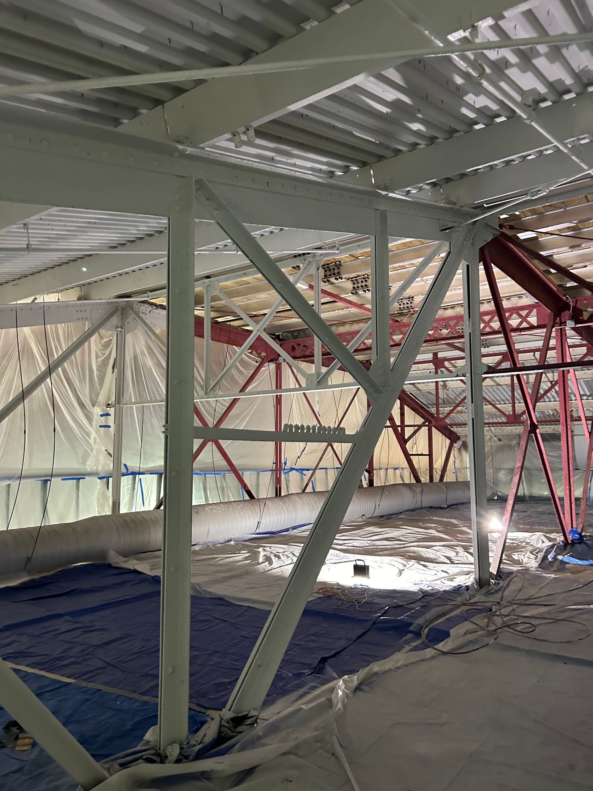 A large building under construction with a lot of metal beams.