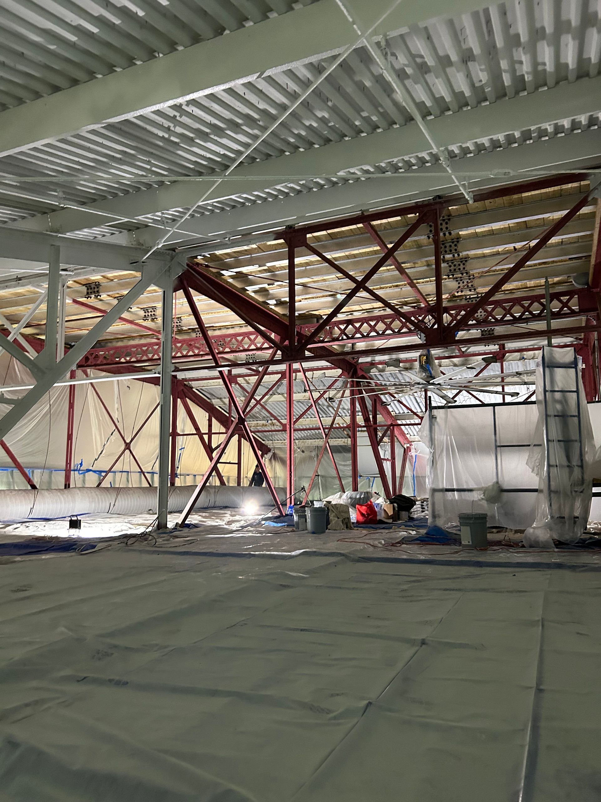 A large building under construction with a lot of metal beams.