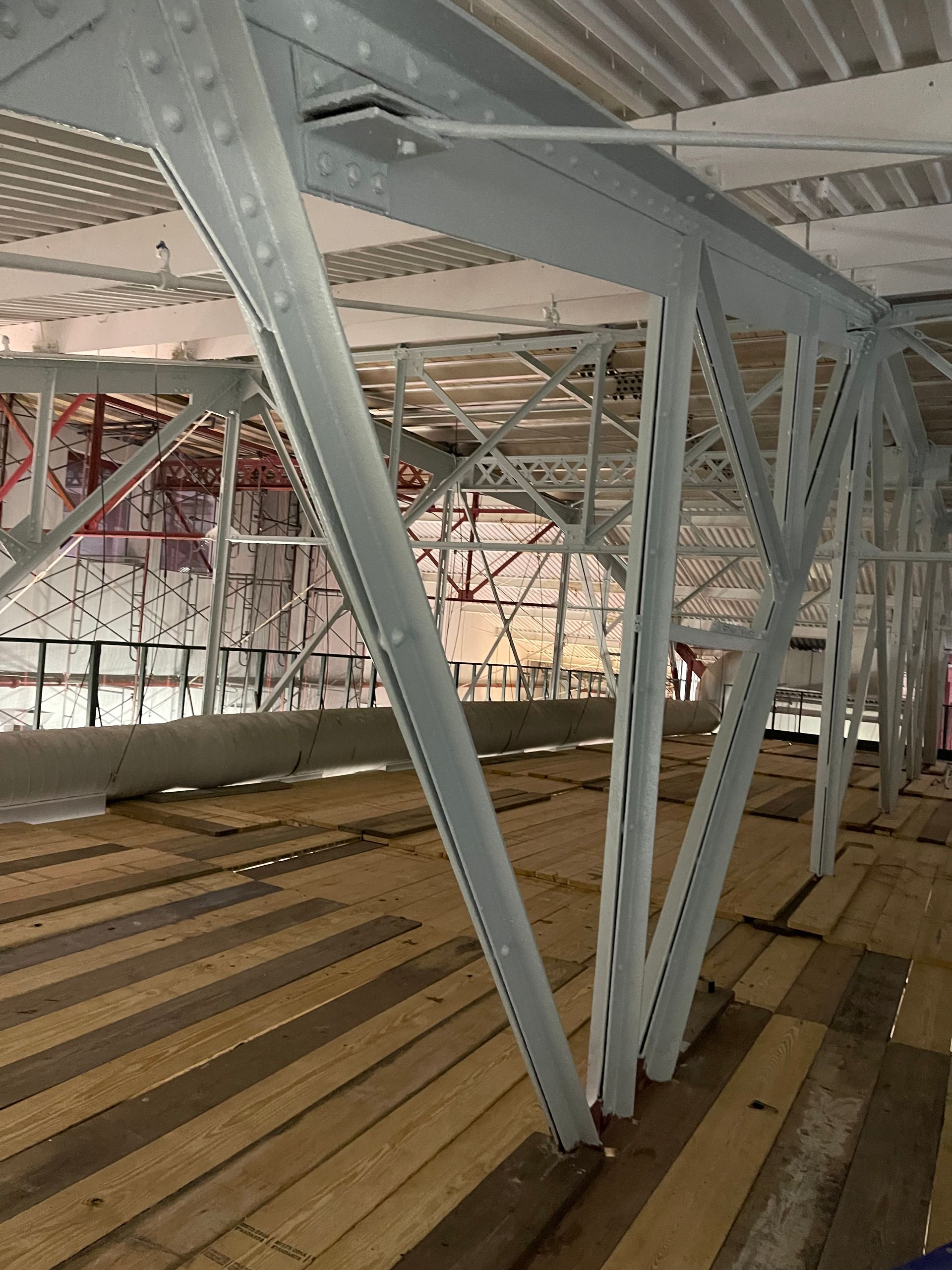 A large metal structure with a wooden floor underneath it