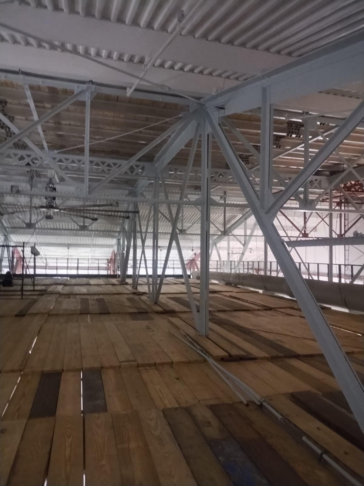 A large empty building with a wooden floor