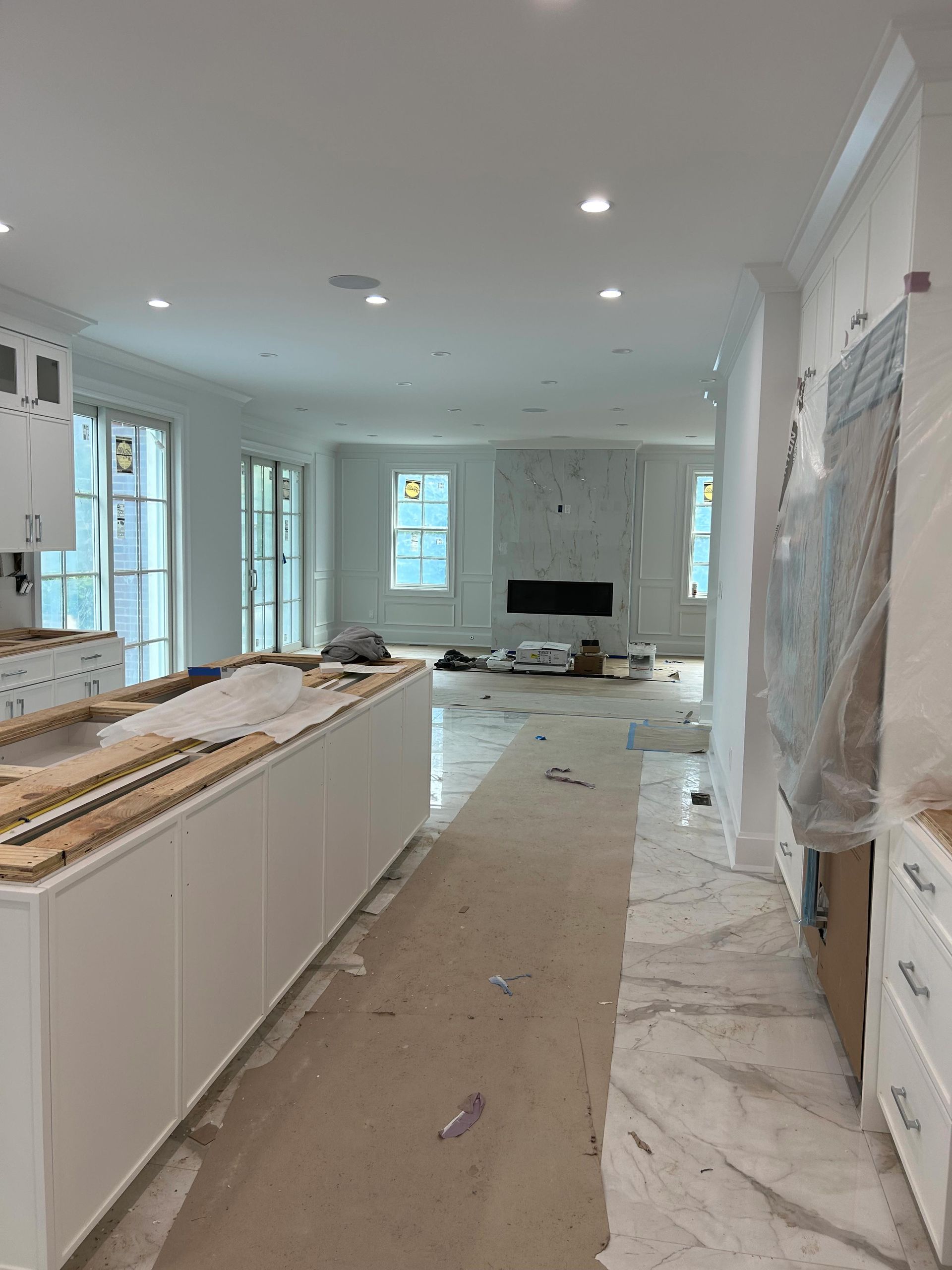 A kitchen and living room are being remodeled in a house