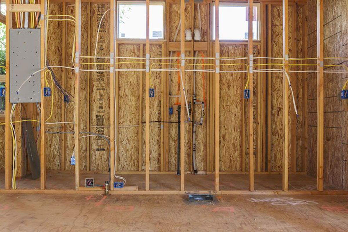 A row of gas pumps are lined up in a parking lot.