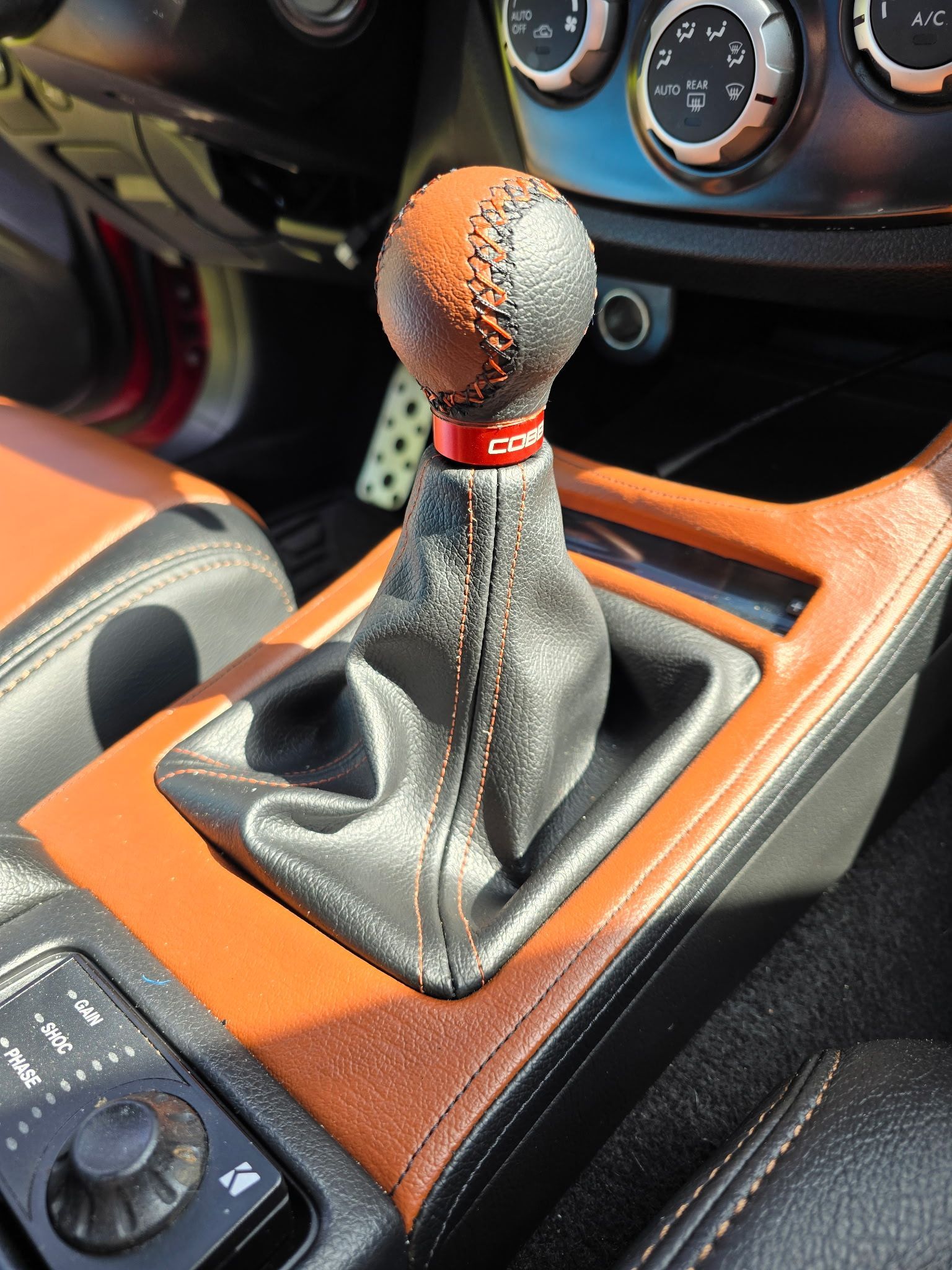 a close up of a leather gear shifter in a car