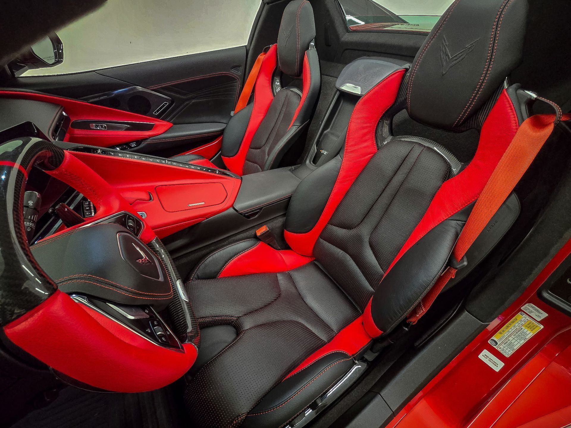 the interior of a sports car with black and red seats