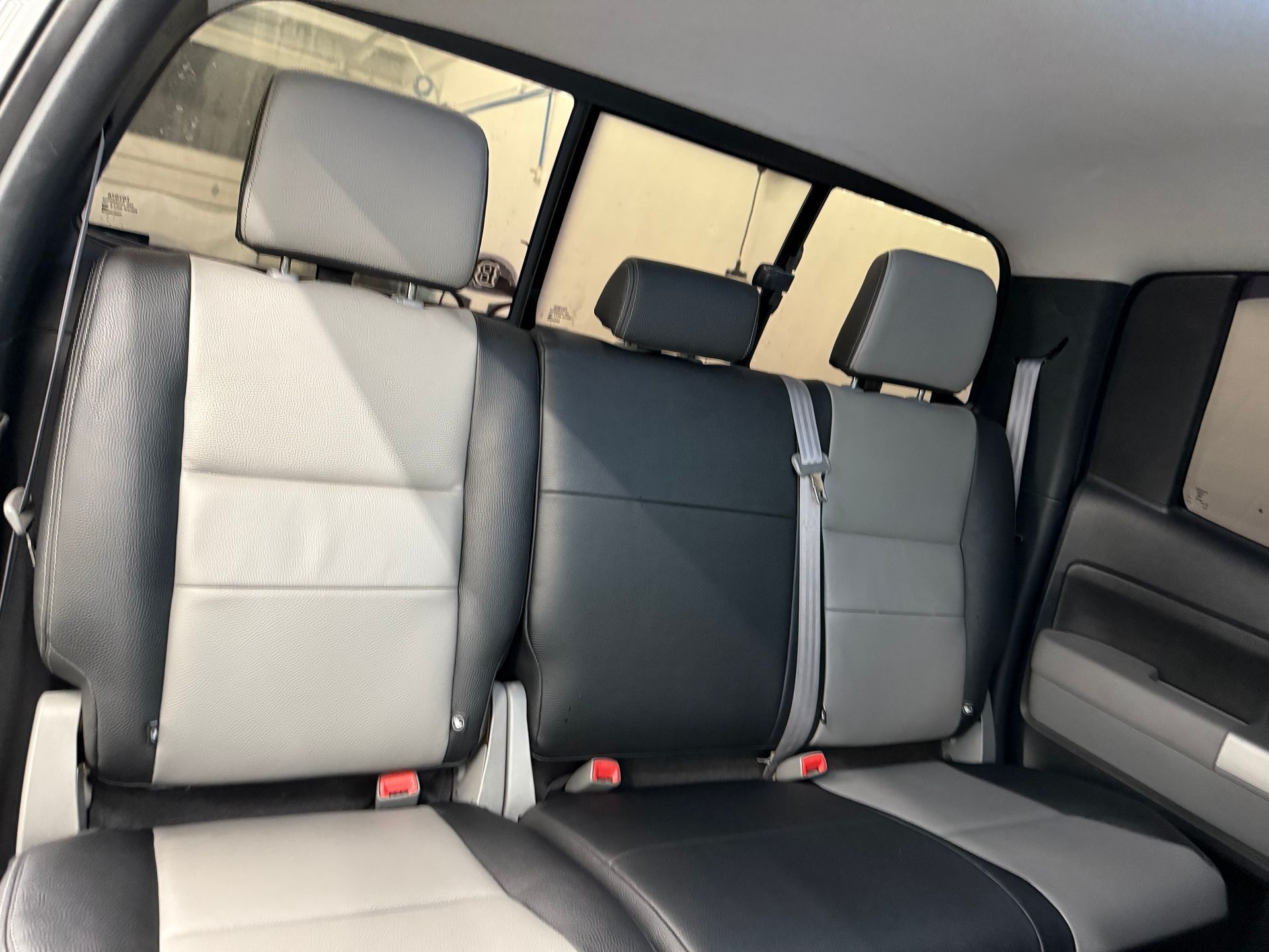 the back seat of a car with black and white seats