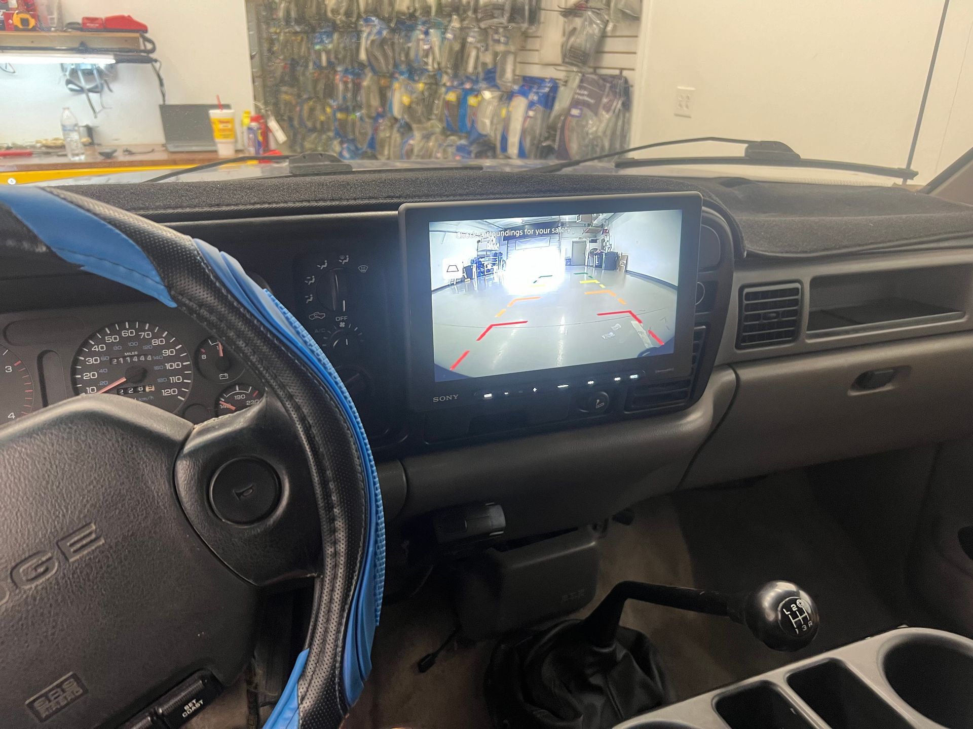 the inside of a car with a rear view camera on the dashboard