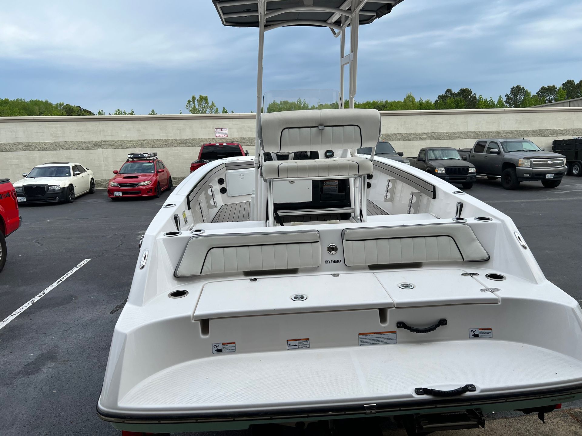 A white boat is parked in a parking lot
