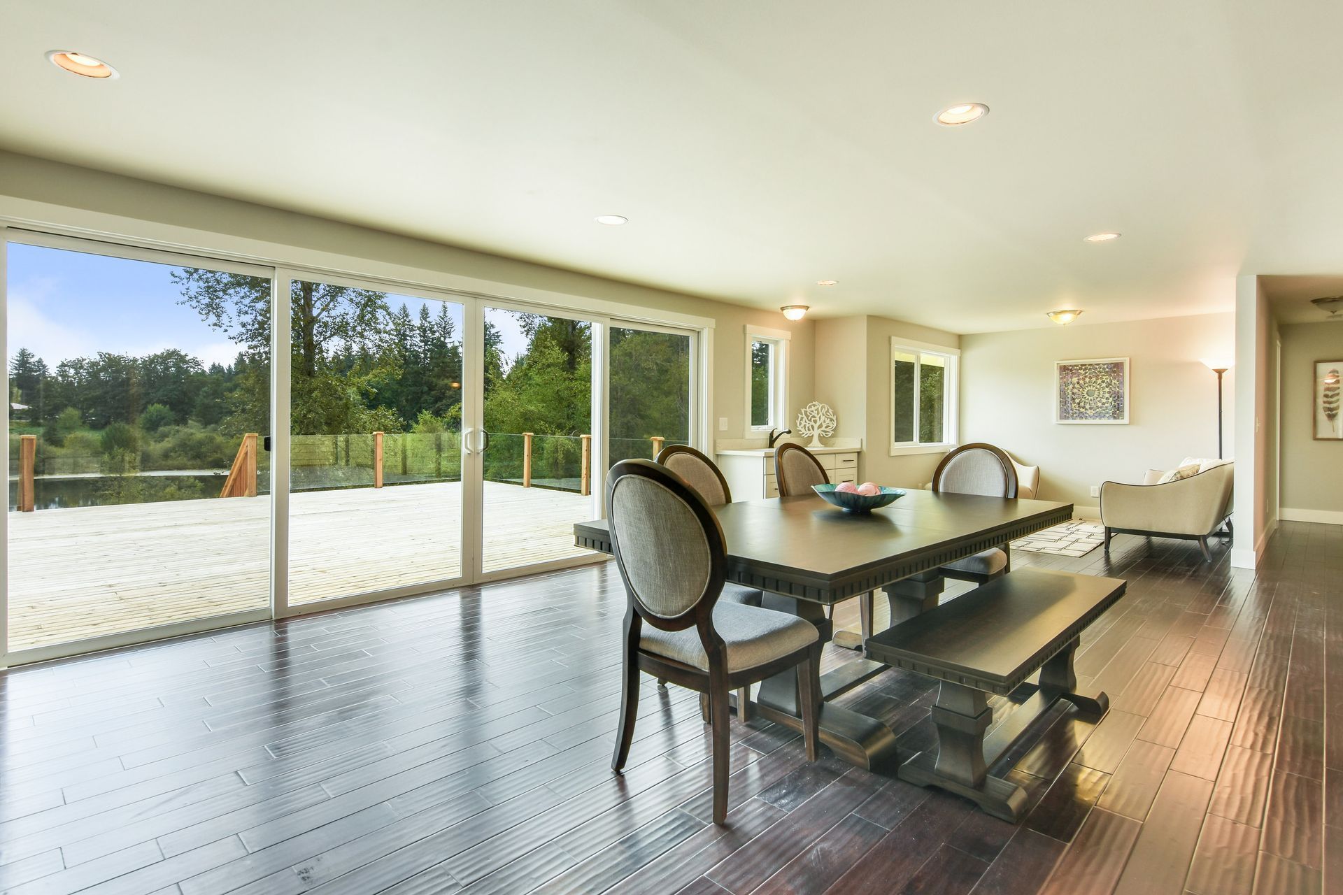 A dining room with a table and chairs and sliding glass doors