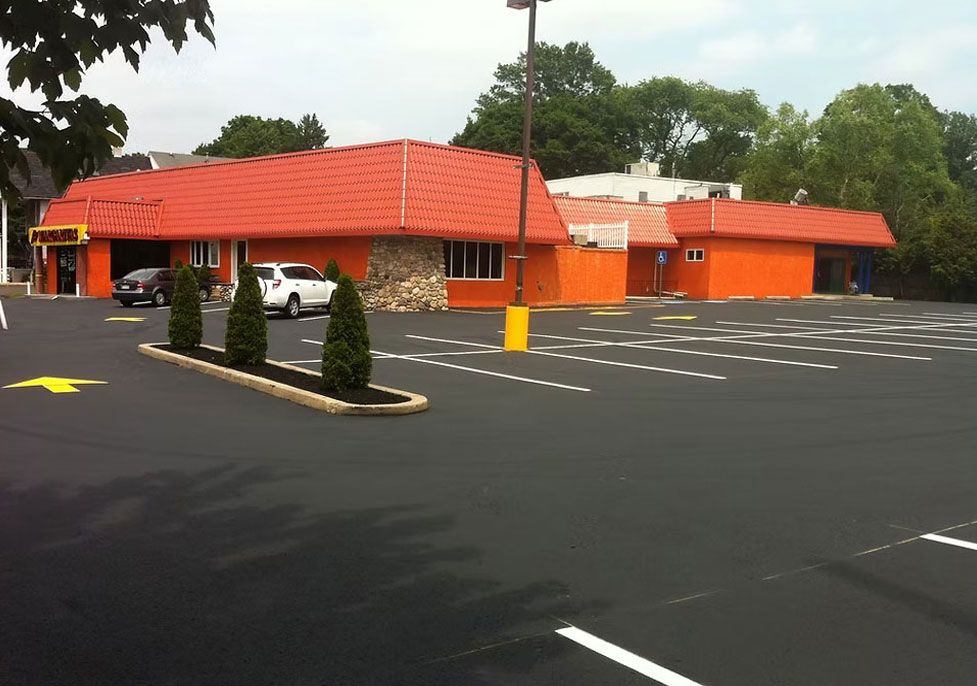 Orange restaurant building with red roof on an empty parking lot - after