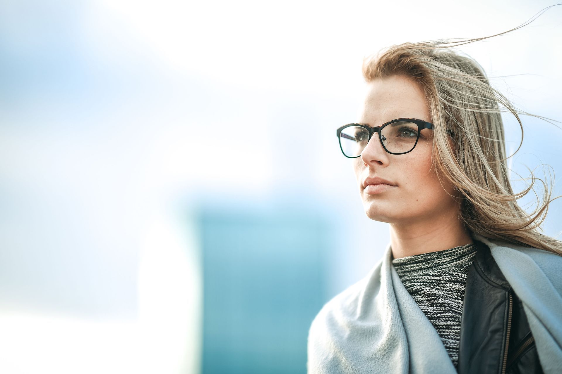 a woman wearing glasses and a scarf