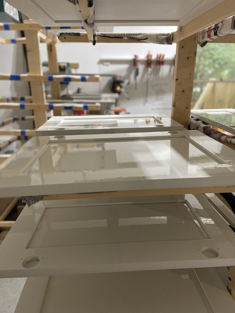 White shelving unit with transparent trays inside a bright room