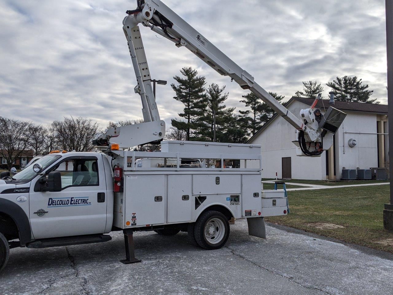 A white utility truck with a crane attached to it