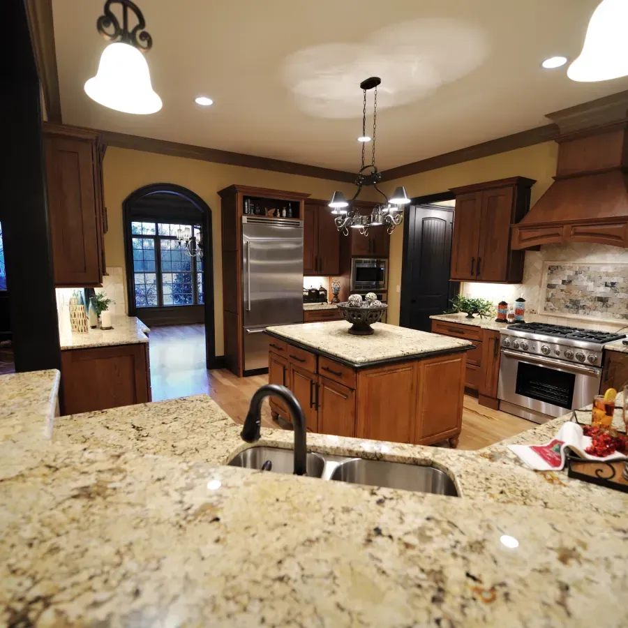 A kitchen with granite counter tops and stainless steel appliances