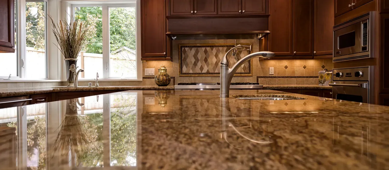 A kitchen with a granite counter top and a sink.
