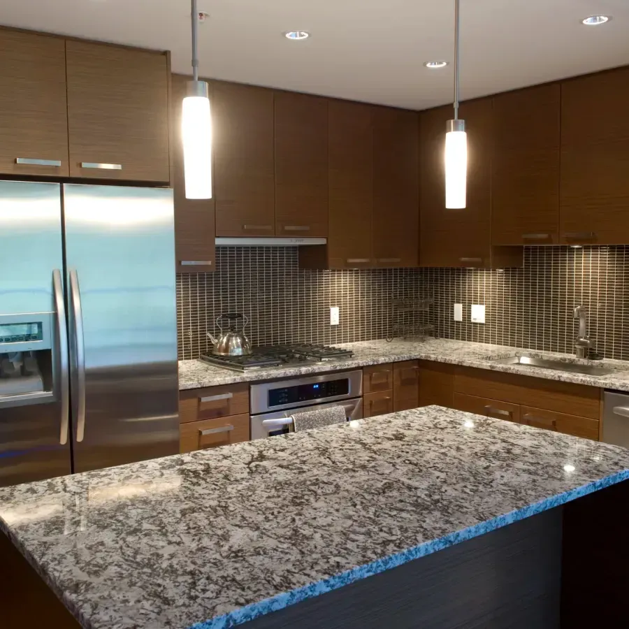 A kitchen with granite counter tops and stainless steel appliances