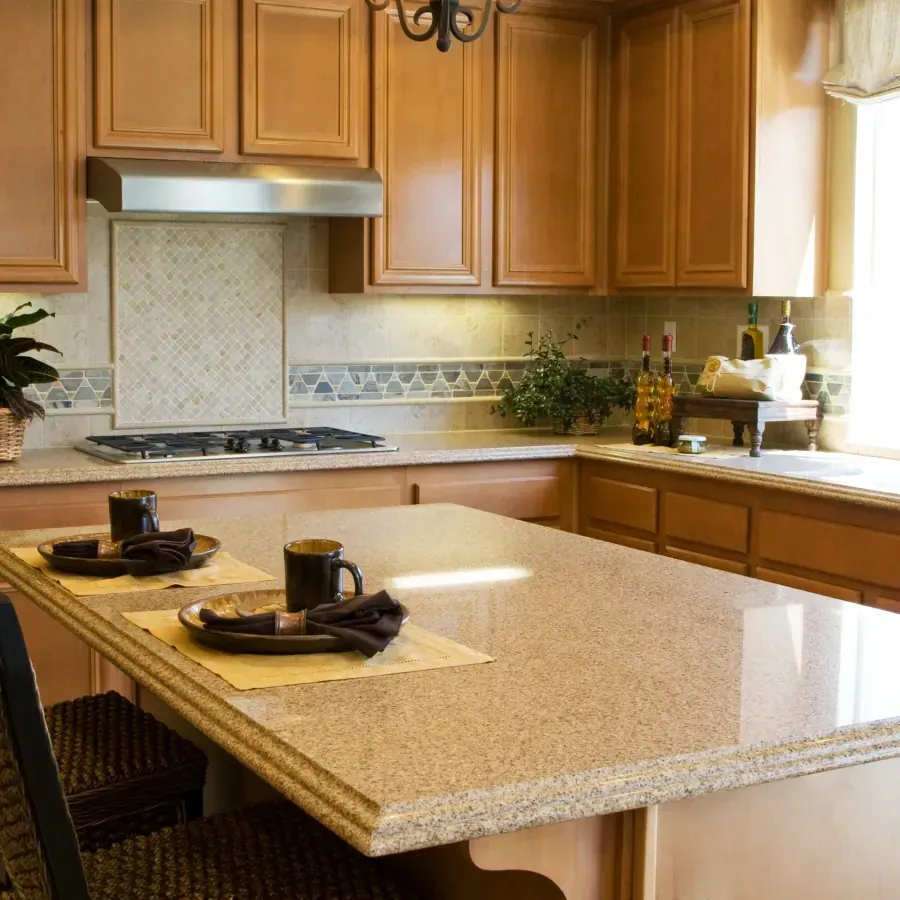 A kitchen with granite counter tops and wood cabinets