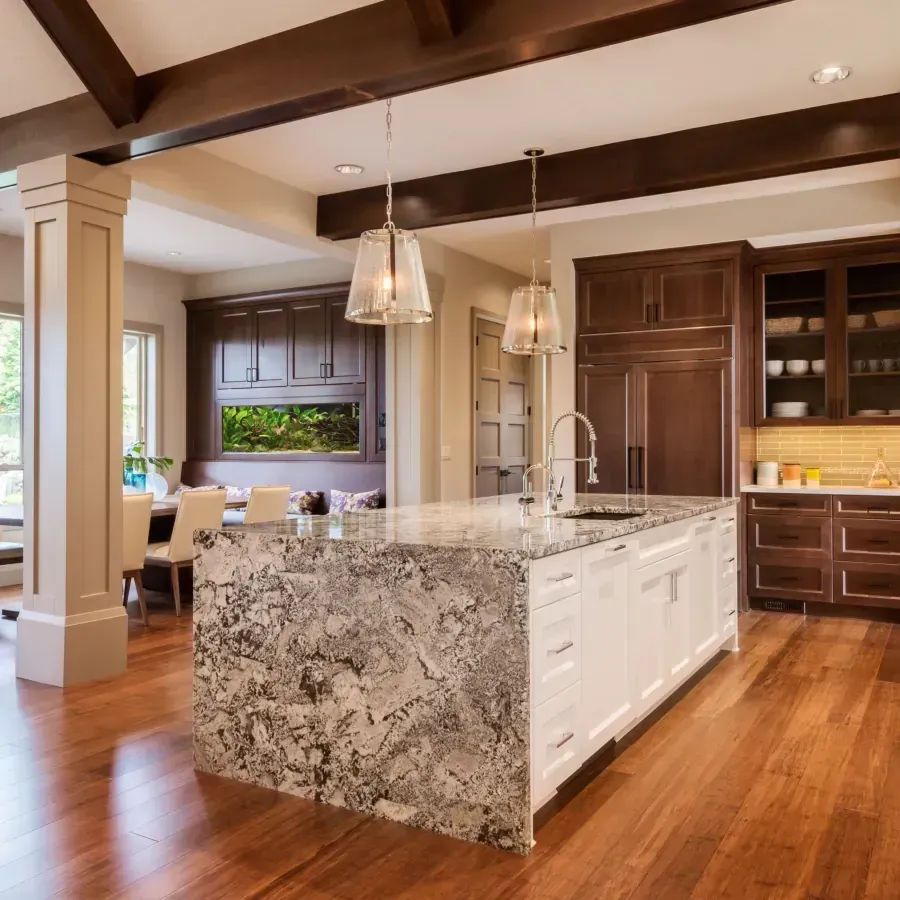 A kitchen with a large granite counter top